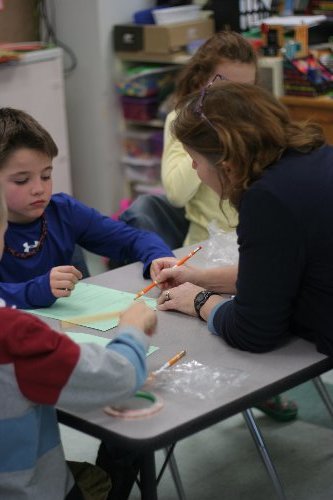 Mrs. K helping students diagram their electrical circuit!