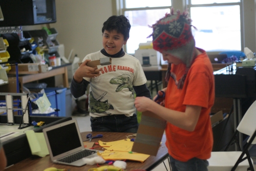 One student (left) working on the handle of the joystick, while his partner works on the box to contain it. 