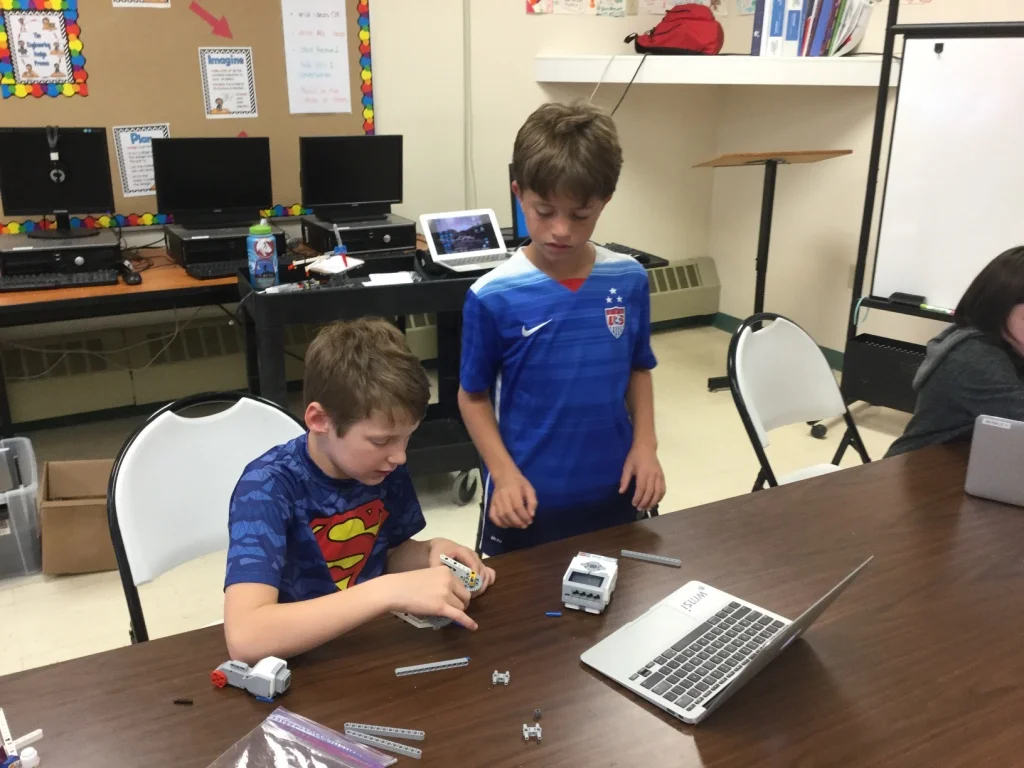 STEM Explorers designing a sweet gear system for their robotic drawing arm!