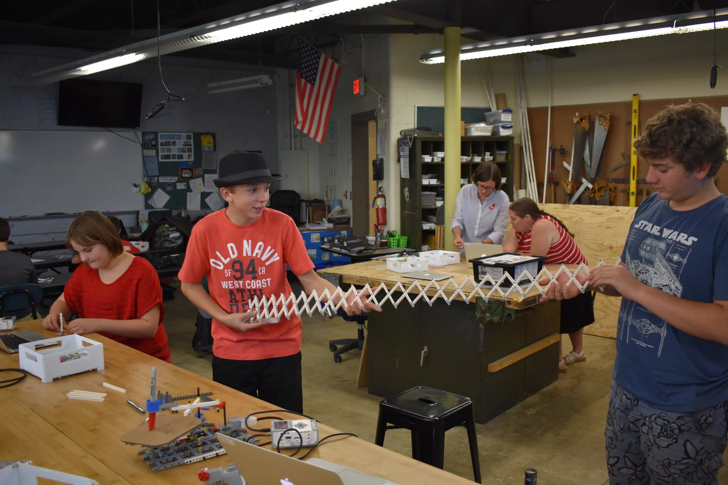 Some very excited Youth Leaders putting together the longest scissor arm EVER!