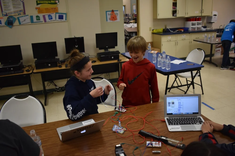 Milan students wiring up game controllers for their new creation!