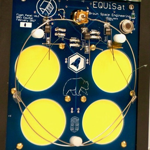  A close up of the EQUiSat’s antenna holding system. The three nichrome loops with the string running through them are just visible between the three sets of parallel strips of metal just above the LEDs 