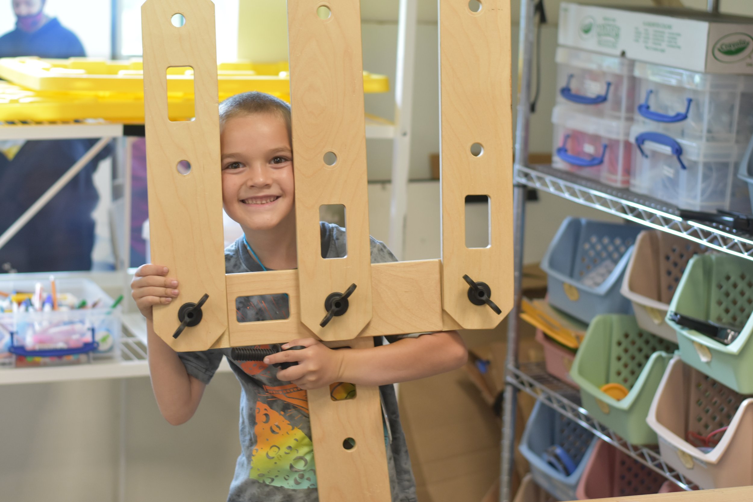  Student peeks through his rigamajig creation 