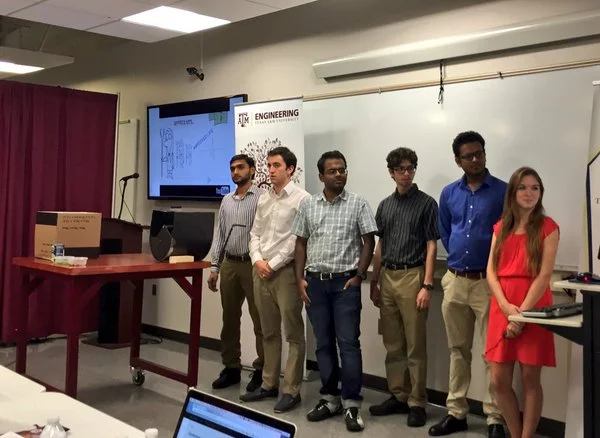 The "Peas Maker" Team presenting their winning design for a pigeon pea desheller. 