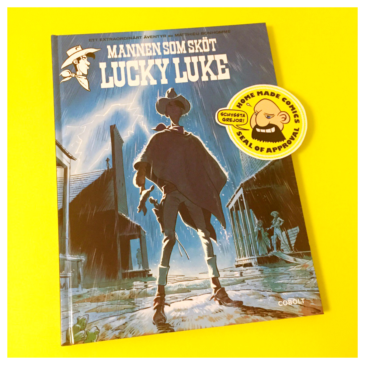 Home Made Comics Seal of Approval #165. Mannen som sköt Lucky Luke av Matthieu Bonhomme utgiven av Cobolt 2016.