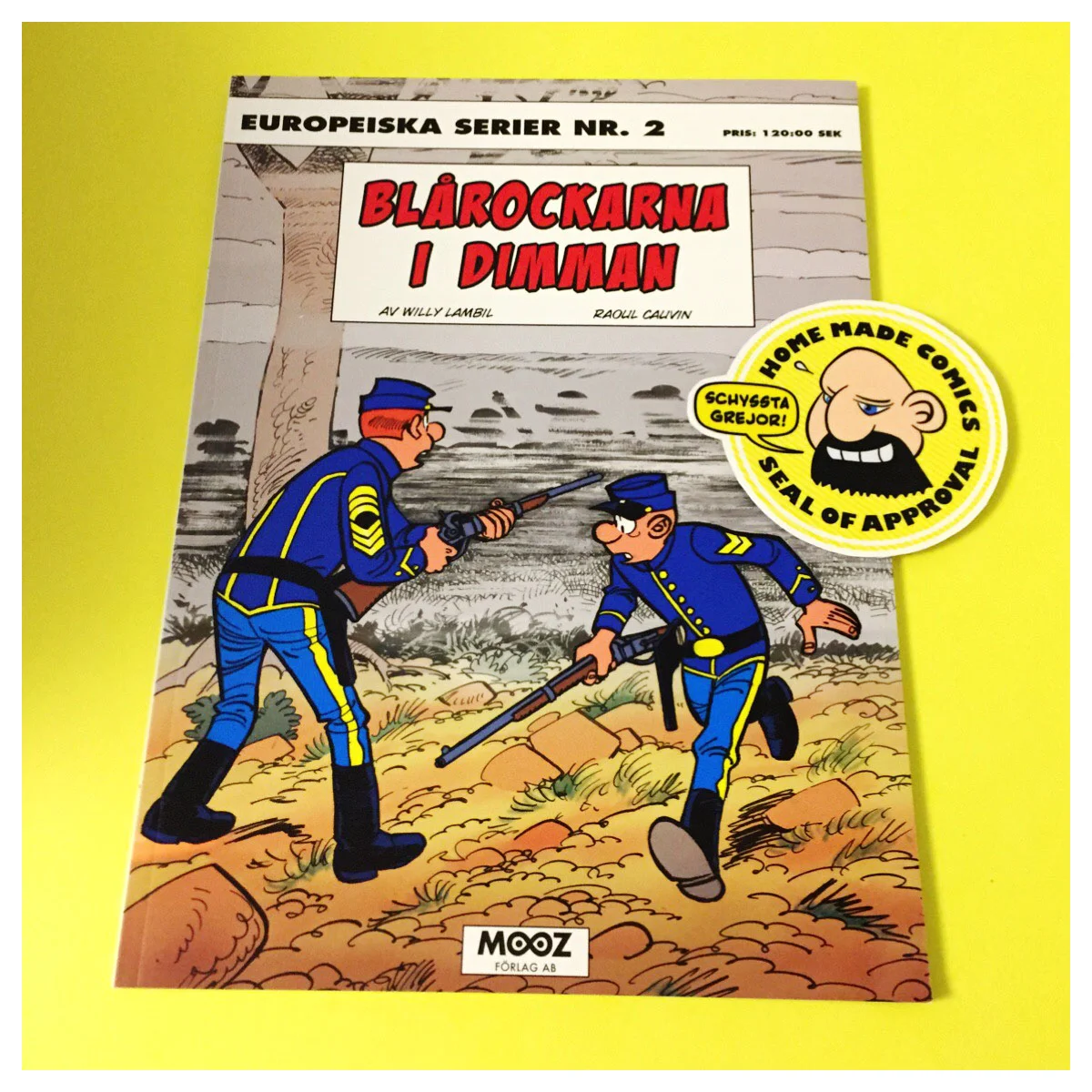 Home Made Comics Seal of Approval #181. Blårockarna i dimman av Willy Lambil och Raoul Cauvin utgiven av Mooz 2014.