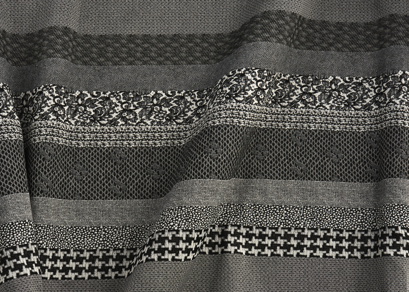 After visiting a premier mill source with HBF Textiles, Blanchard found herself moved by the almost-photographic detail level that the mill could achieve by using its extremely fine warp and fill yarns. Based on art strips of personal memories – her wedding dress, her son’s blanket, a favorite pair of trousers – that Blanchard sews together in her studio, her new Remember fabric reflects a woven interpretation of these materials. The end result is a surreal sense of texture, rendered by the mill as stripes of photographic representations of her fondest recollections in crisp black-and-white. Remember comes standard with a Nano-Tex stain-resistant performance finish.
