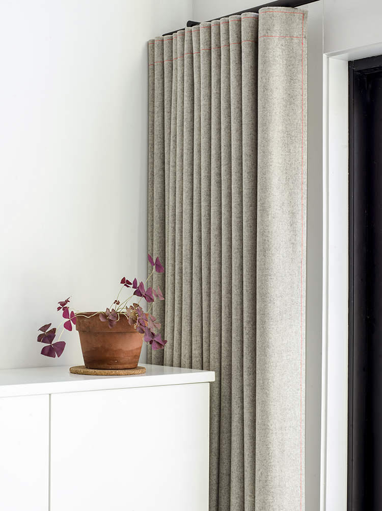 Raw felt curtain with pink stitching