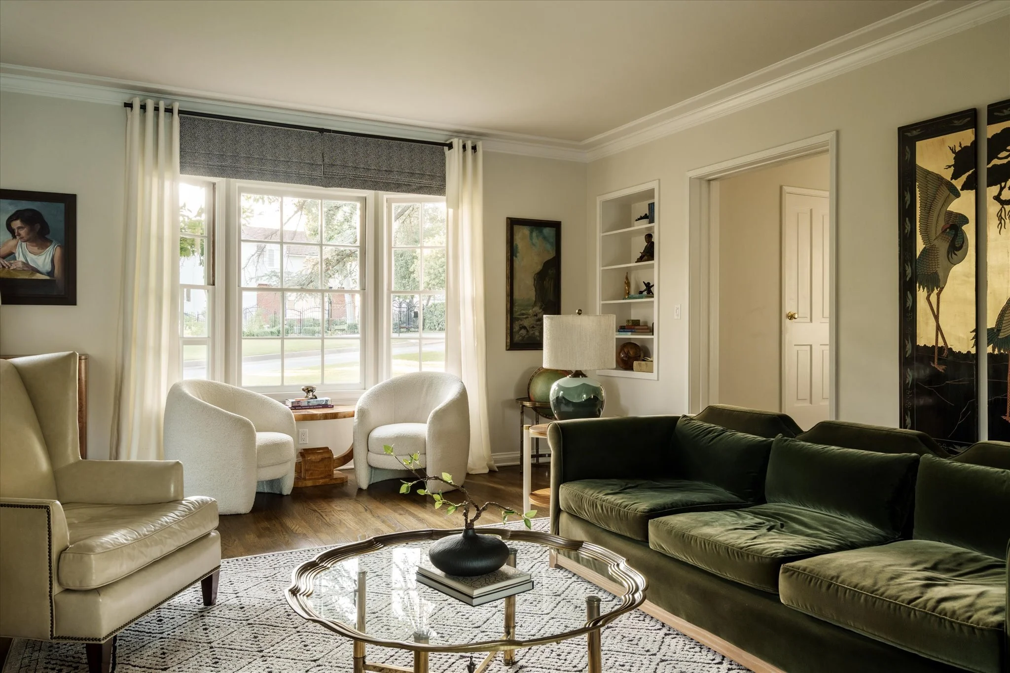 Light-filled formal living room at 1624 Hillcrest Ave with original hardwood floors, bay window and built-in shelving.