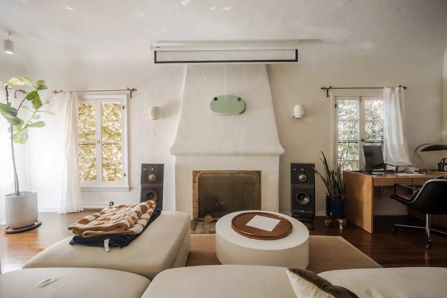 Bright living room with original fireplace and hardwood floors in a Beachwood Canyon fourplex apartment