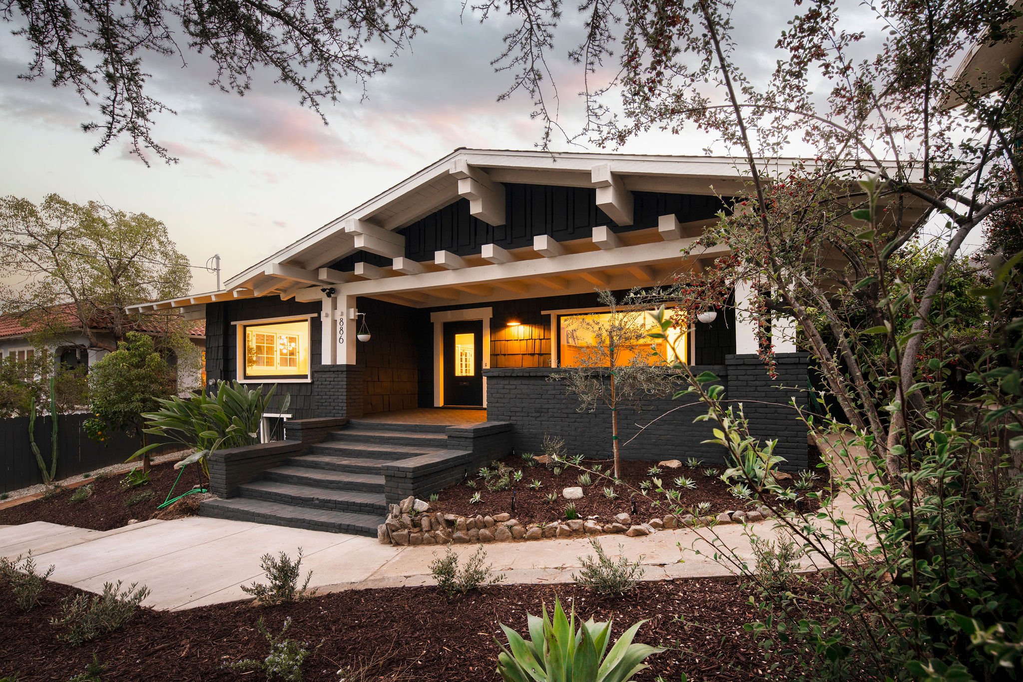 Beautifully updated Craftsman bungalow in Silver Lake, Los Angeles, photographed at dusk with warm interior lighting
