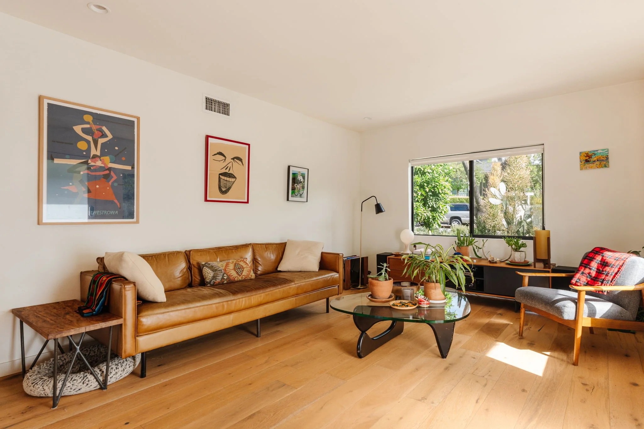 Modern living room in Highland Park real estate listing featuring open layout, hardwood floors, and natural light
