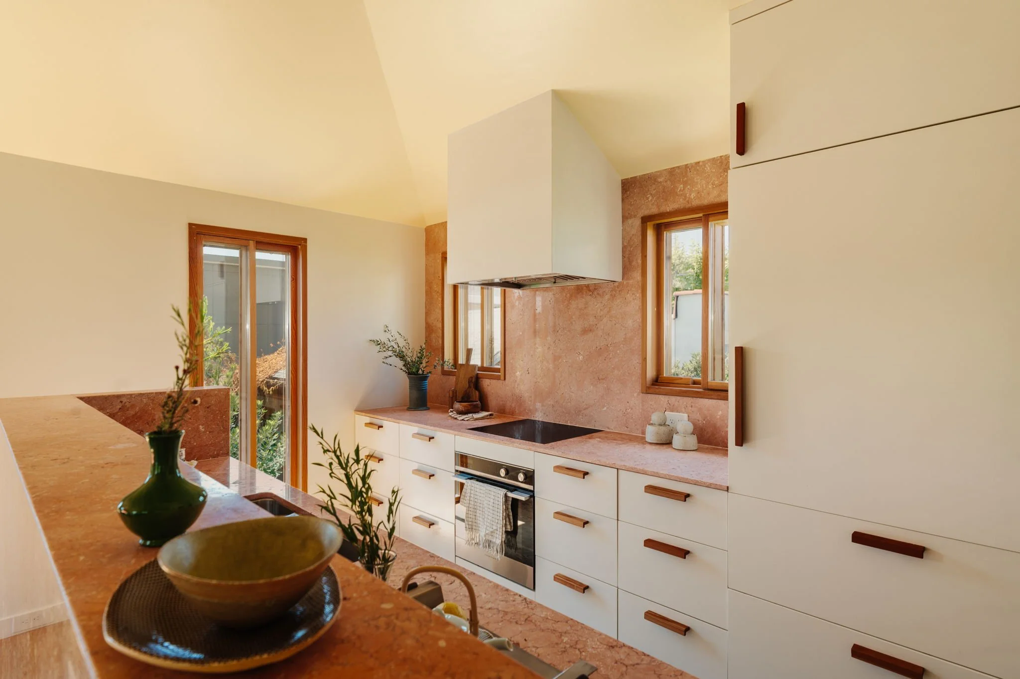 Architectural kitchen with marble countertops, custom cabinetry, and wood accents in Silver Lake home