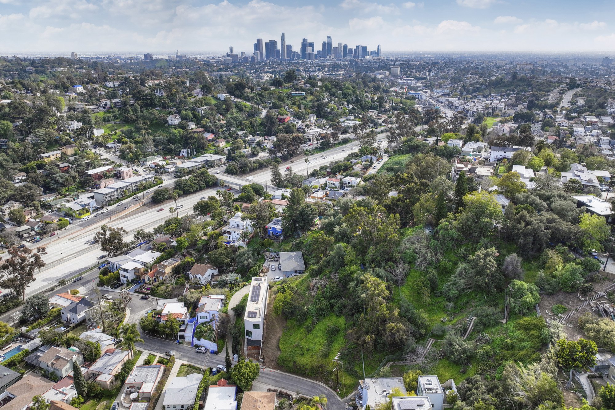 Aerial view of Silver Lake residential neighborhood near the 2 freeway with Downtown Los Angeles skyline visible in the distance