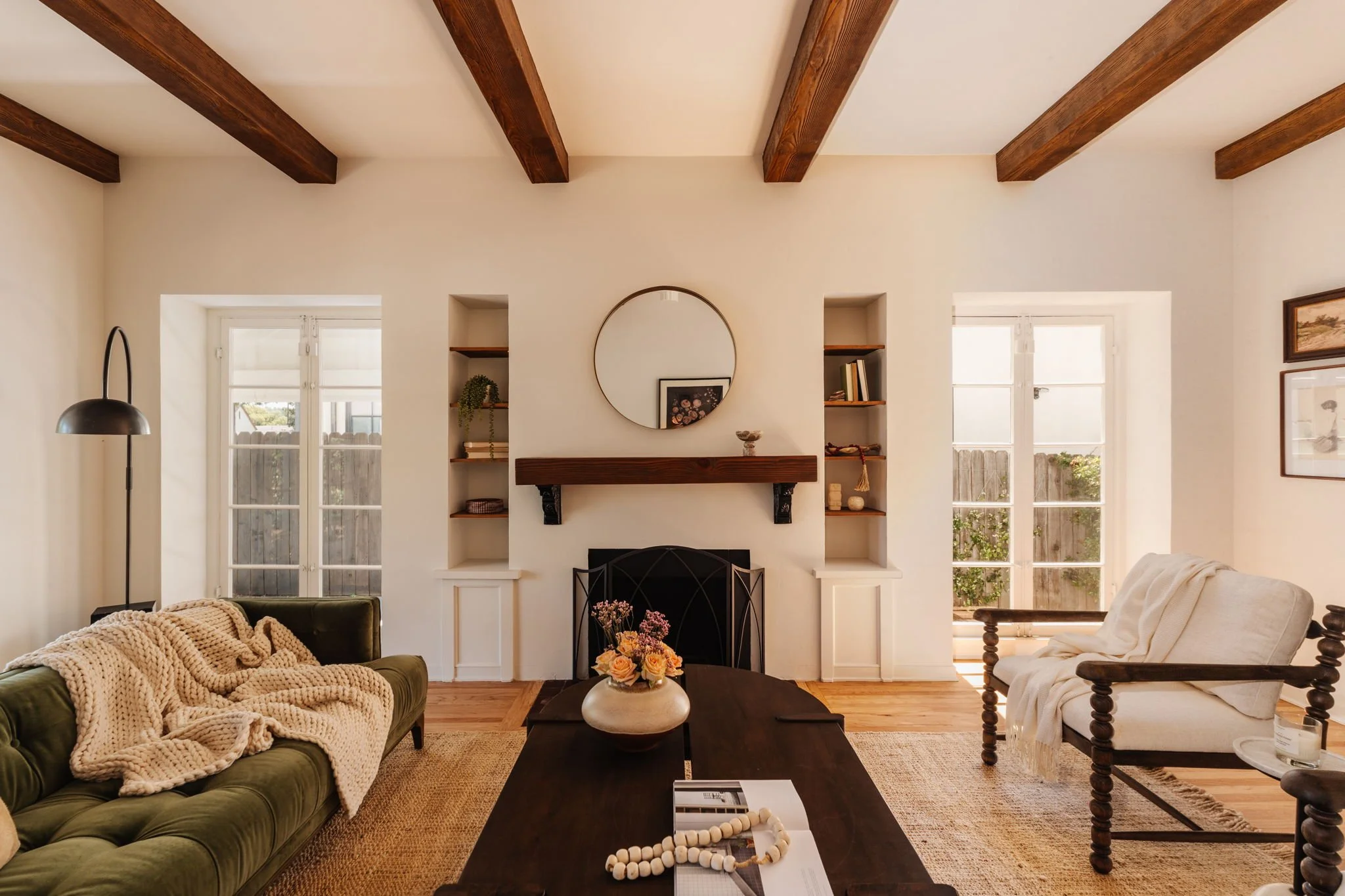 Living room with exposed wood beam ceiling and fireplace in a Craftsman home in Atwater Village Los Angeles