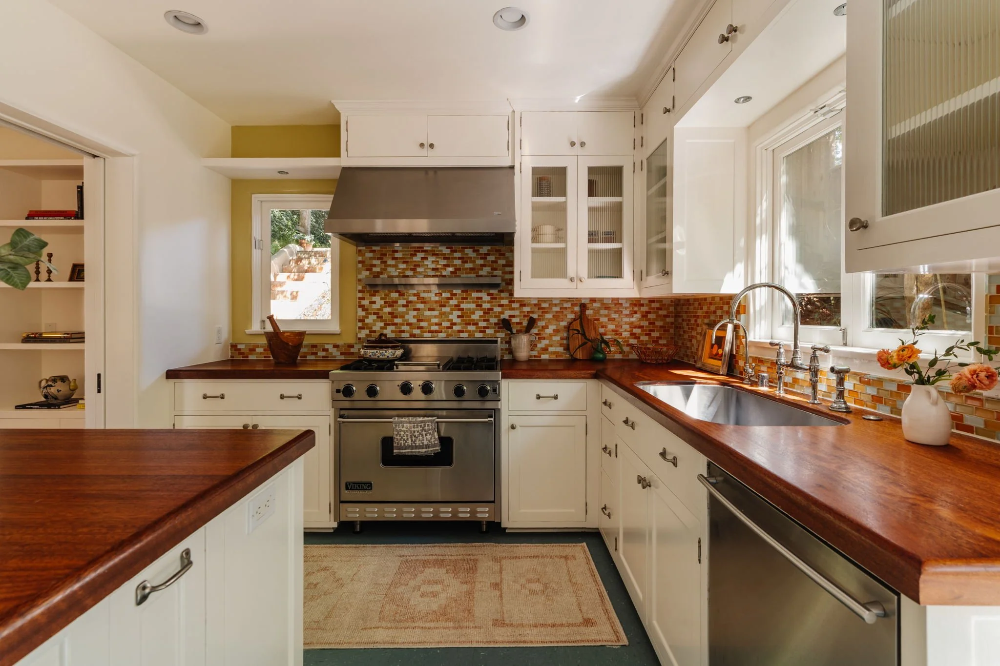 Updated kitchen in Silver Lake Spanish home with tile backsplash and wood countertops