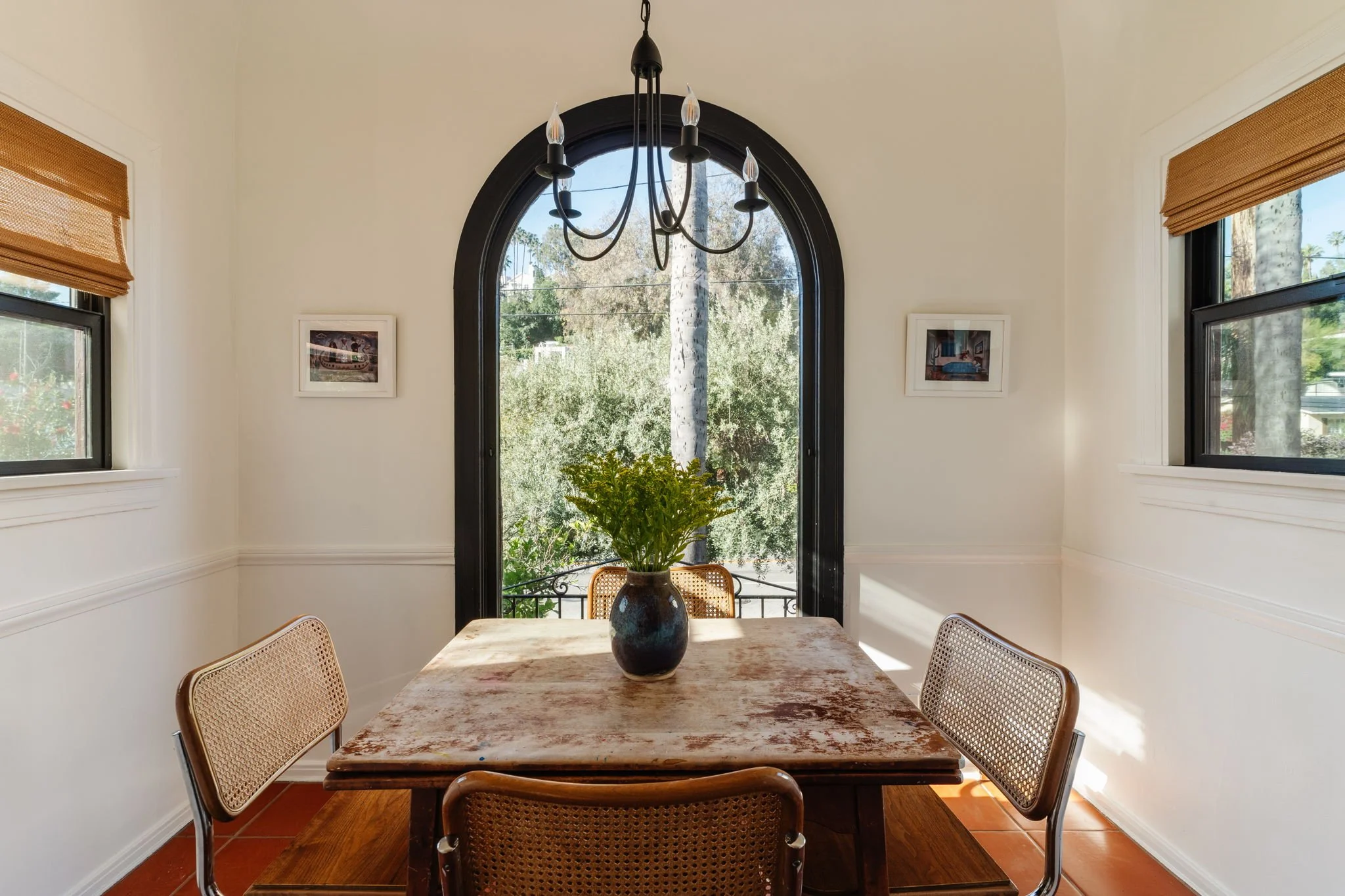 Dining area with arched window in 1925 Spanish Revival home Los Angeles