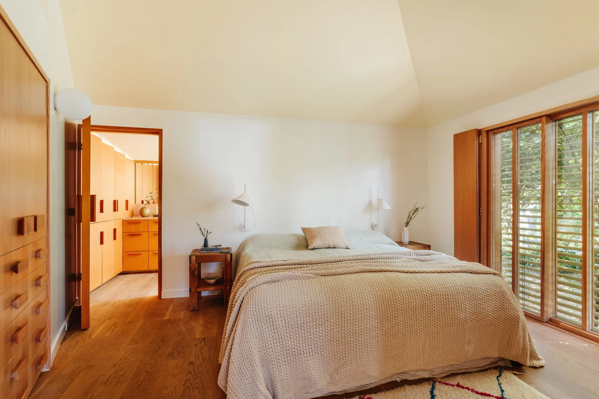 Primary bedroom with wood floors, natural light, and clean modern design in Silver Lake architectural home