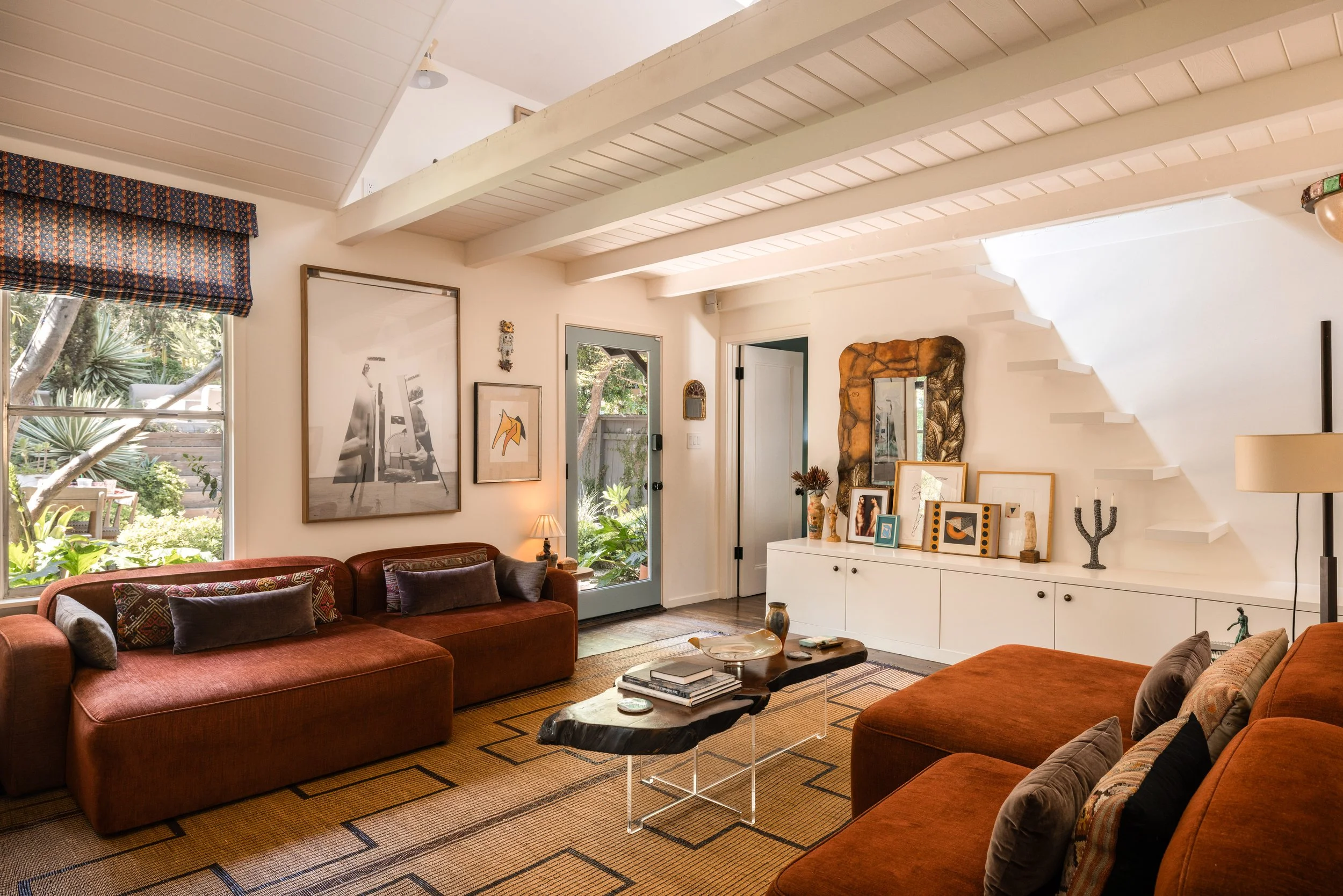 Open living space at 1452 Westerly Ter showing exposed beams, bonus loft area, hardwood floors, and architectural details.