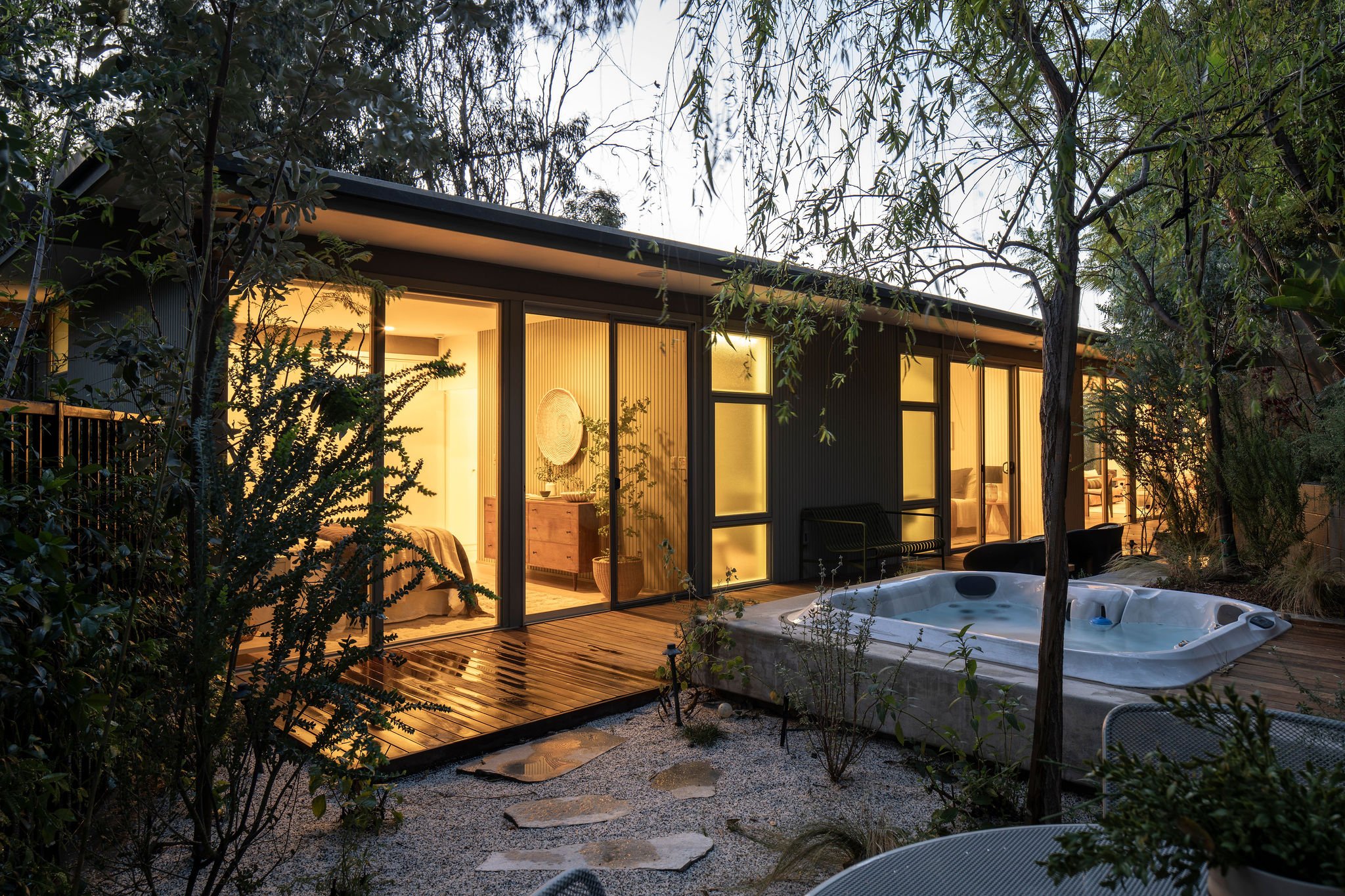 Hollywood Hills mid-century modern home with hot tub and landscaped outdoor living areas at dusk