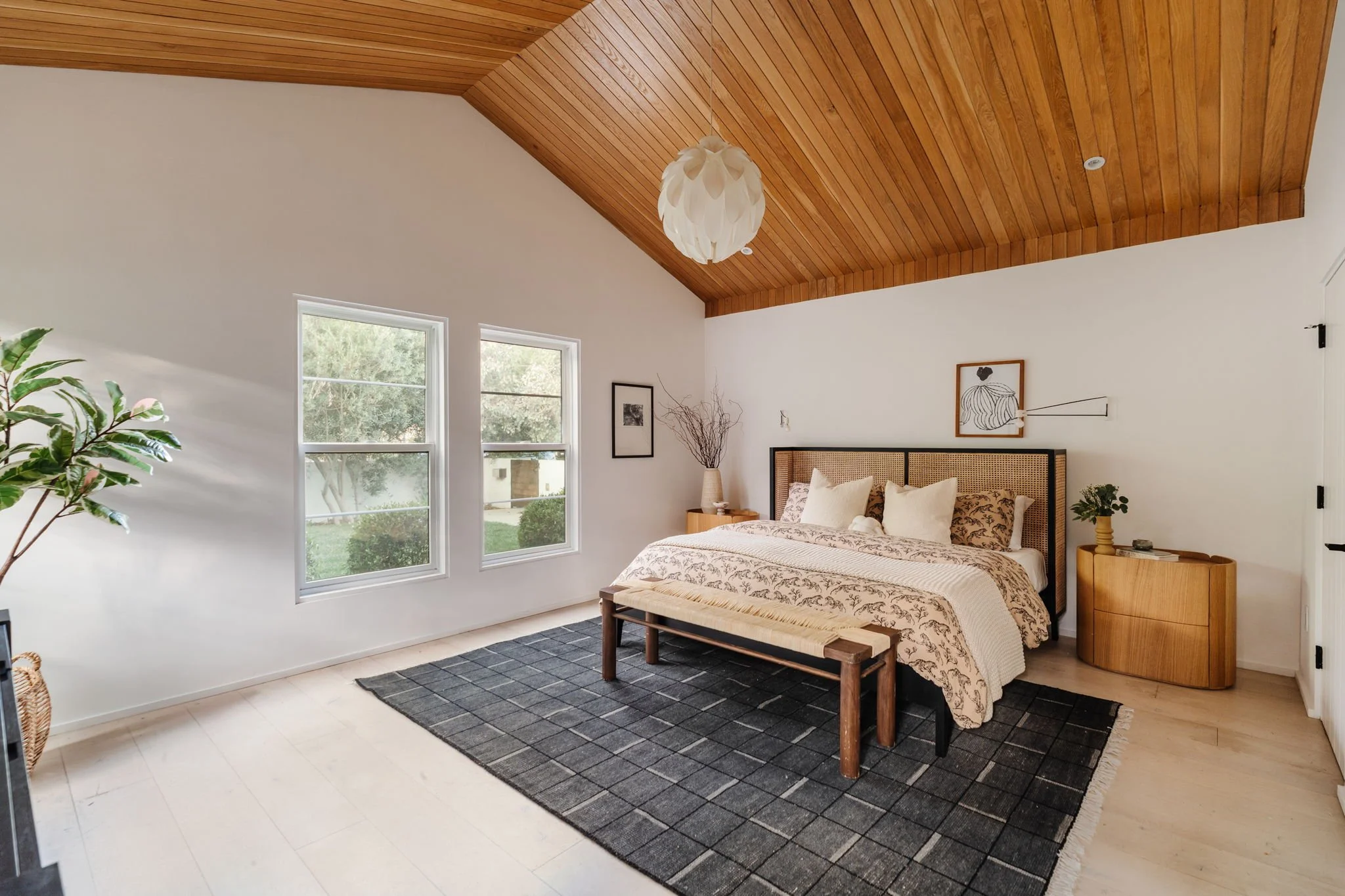 Primary bedroom at 4128 Baywood St in Atwater Village featuring vaulted wood ceiling, large windows, and serene garden views.
