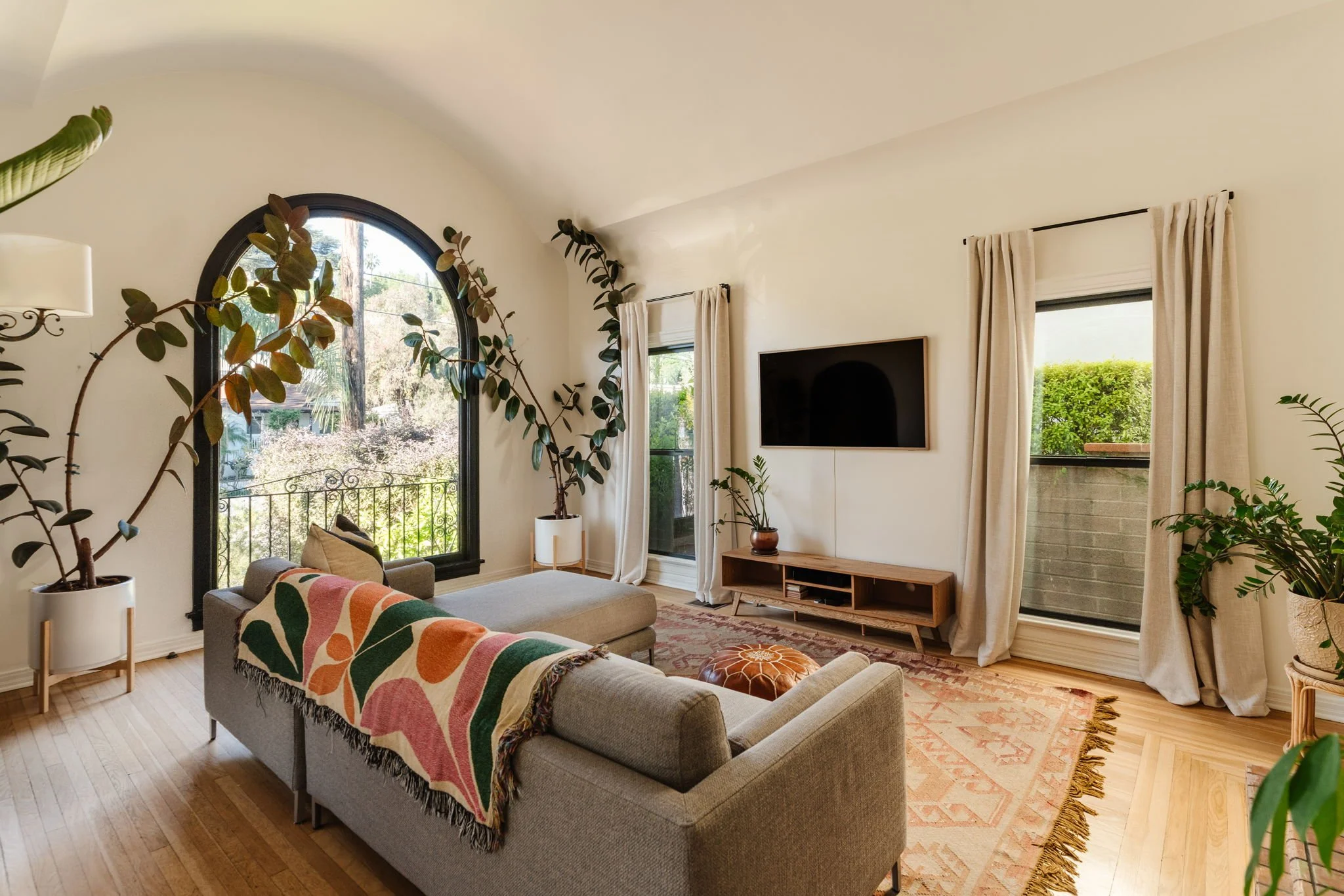 Spanish Revival living room with arched window and natural light in Silver Lake