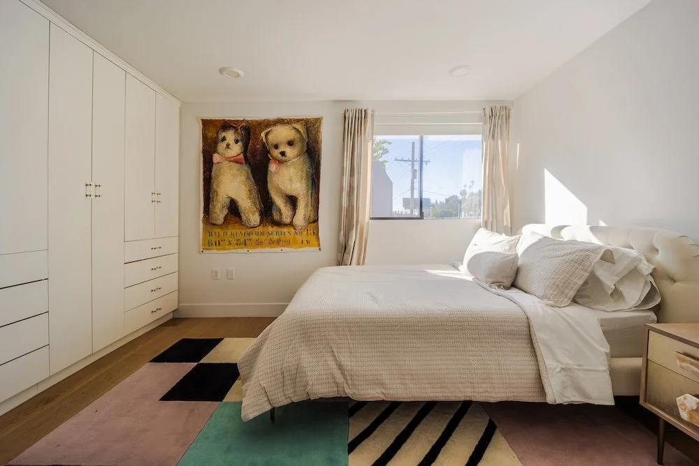 Light-filled primary bedroom with custom closets in a modern Echo Park home