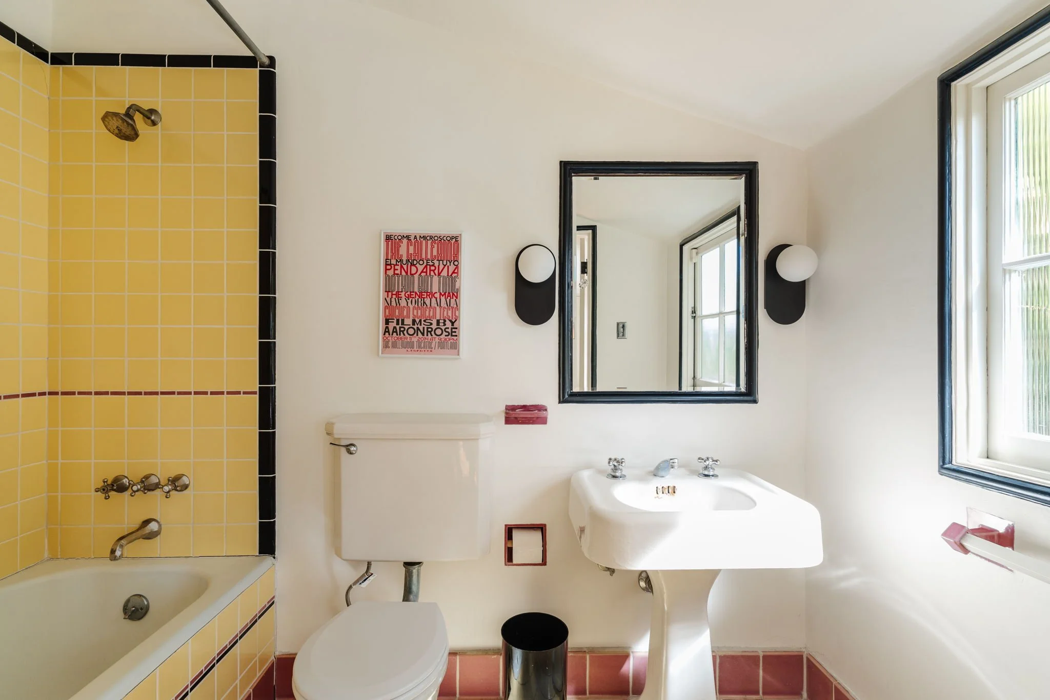 Vintage bathroom with yellow tile, pedestal sink, and period details in Whitley Heights