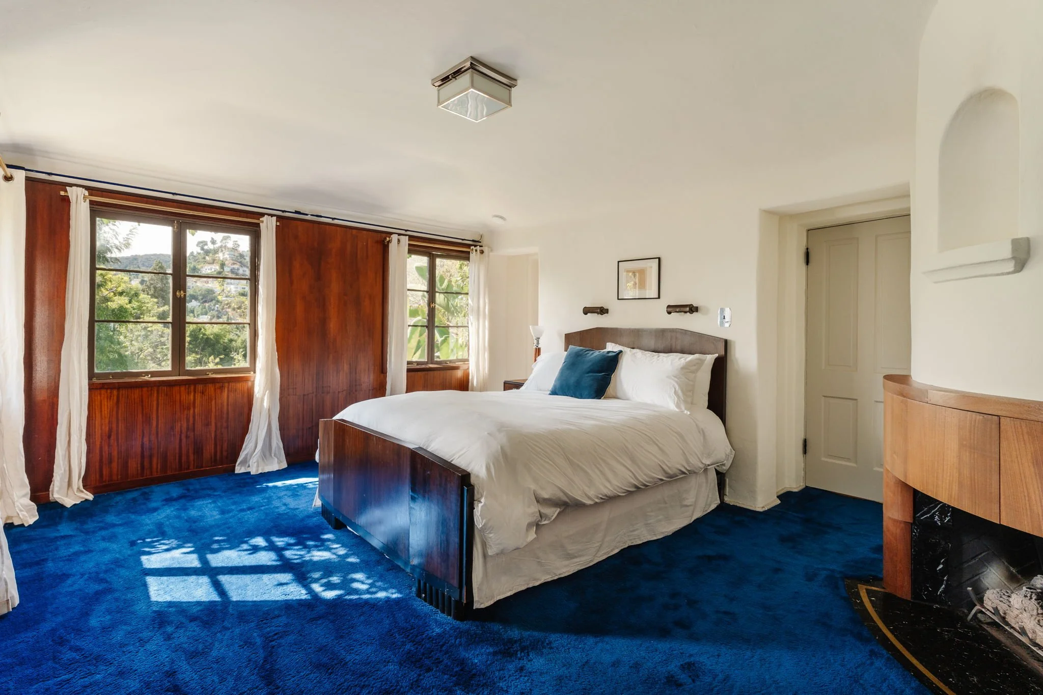 Bedroom with hillside view windows and period character in a Whitley Heights Spanish home