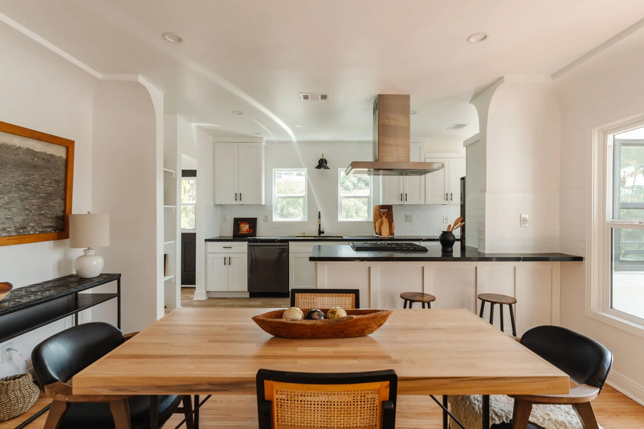 Open dining area and updated kitchen in renovated Los Angeles Spanish duplex