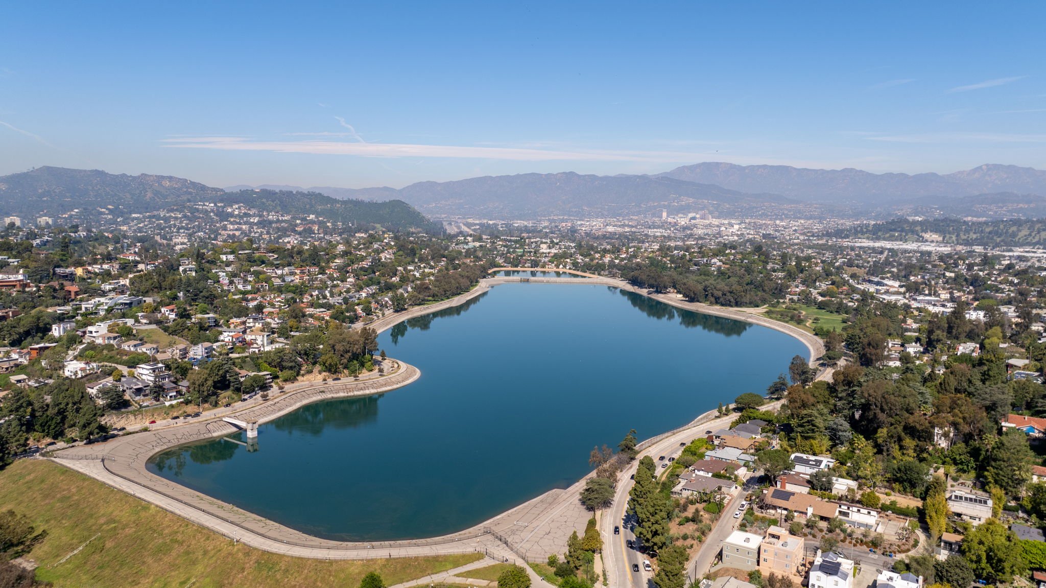 Aerial daytime view of the Silver Lake Reservoir surrounded by hillside homes in Los Angeles