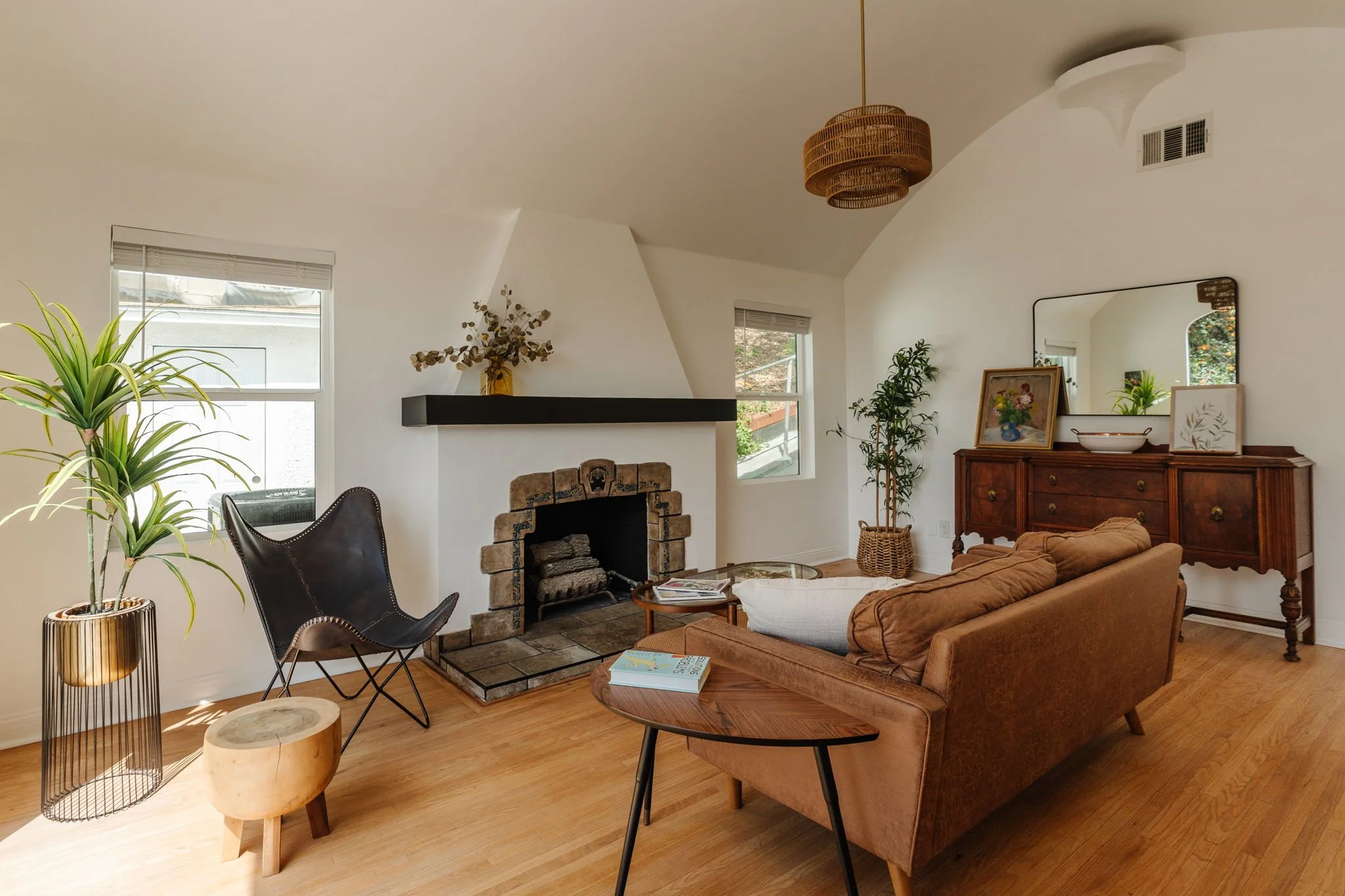 Bright living room with fireplace in renovated Spanish duplex in Los Angeles