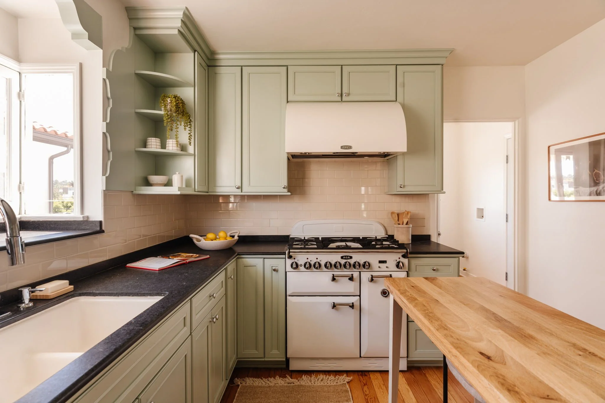 Updated kitchen with Carrera countertops and green cabinetry in a Craftsman home in Atwater Village Los Angeles
