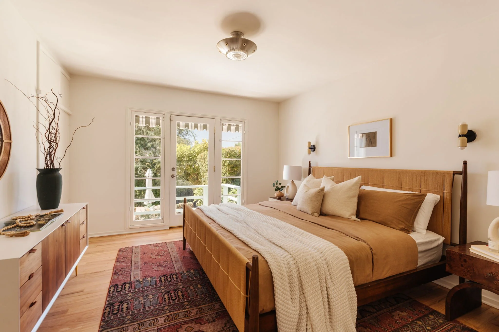 Primary bedroom with French doors opening to backyard deck in a Craftsman bungalow in Atwater Village Los Angeles
