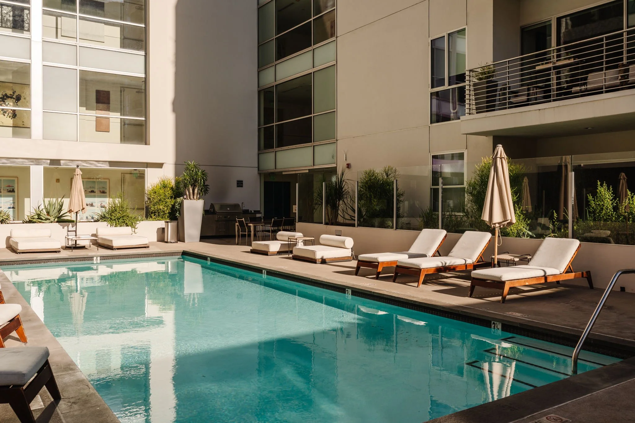 Outdoor swimming pool and lounge area at The Hollywood condominium building
