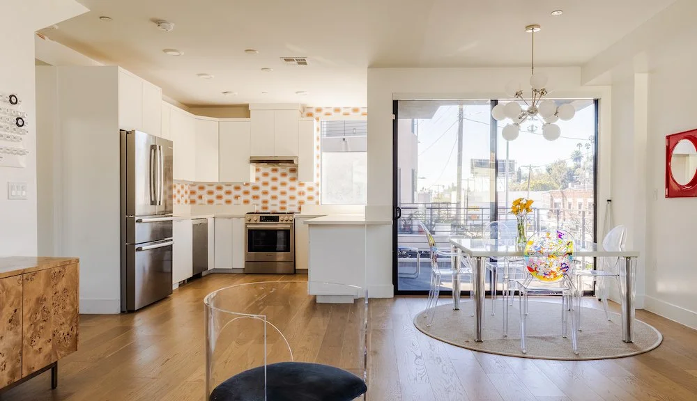 Modern kitchen and dining area with deck access in an Echo Park architectural home