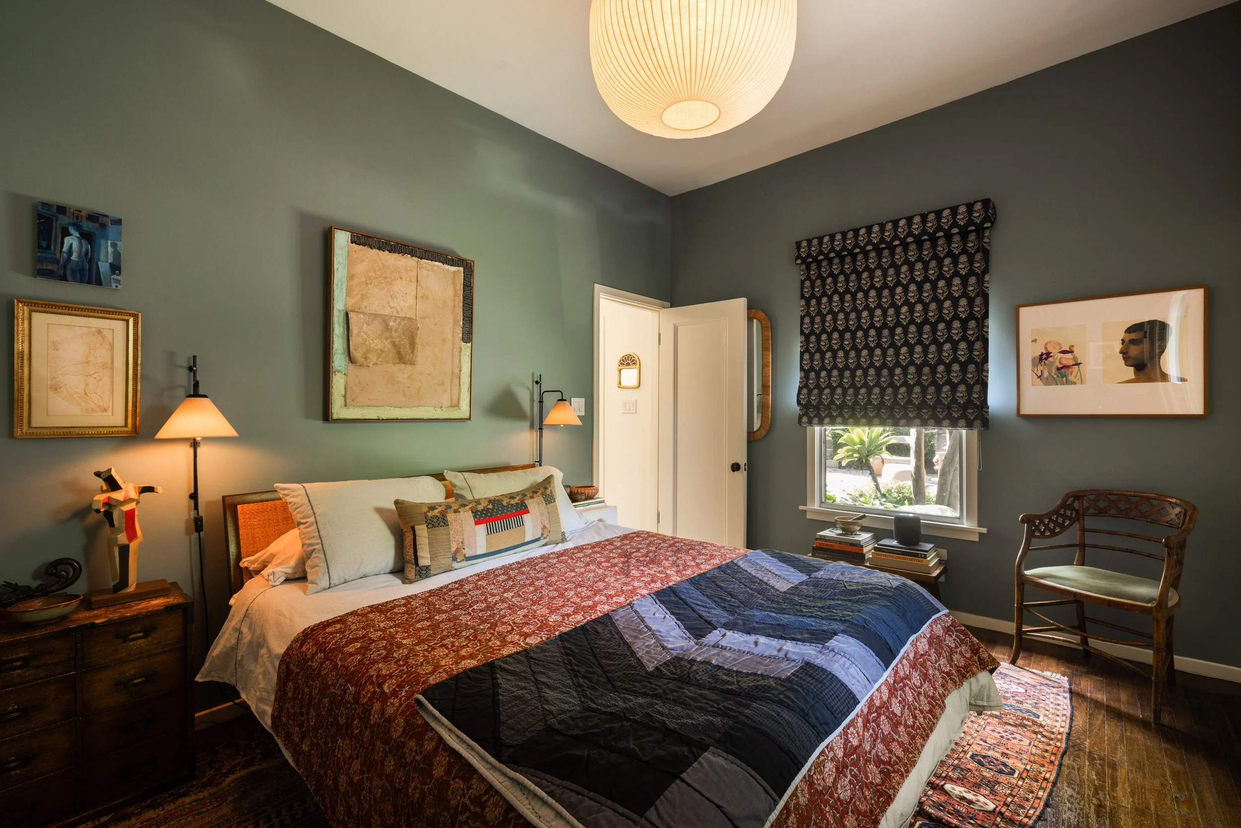 Primary bedroom at 1452 Westerly Ter in Silver Lake featuring hardwood floors, designer wall colors, and garden views.