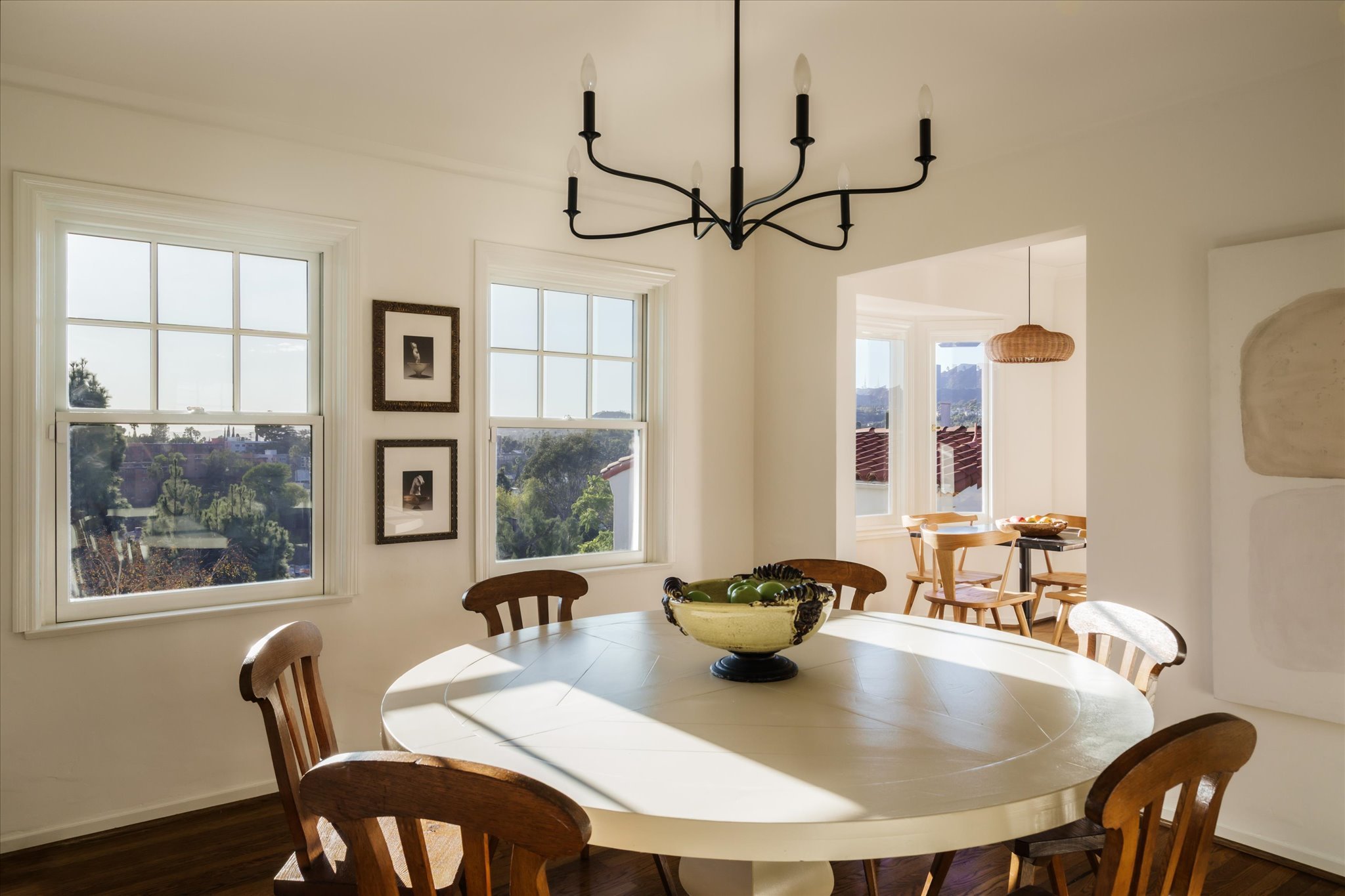 Dining room with a chandelier and large windows overlooking the Silver Lake hillsides.
