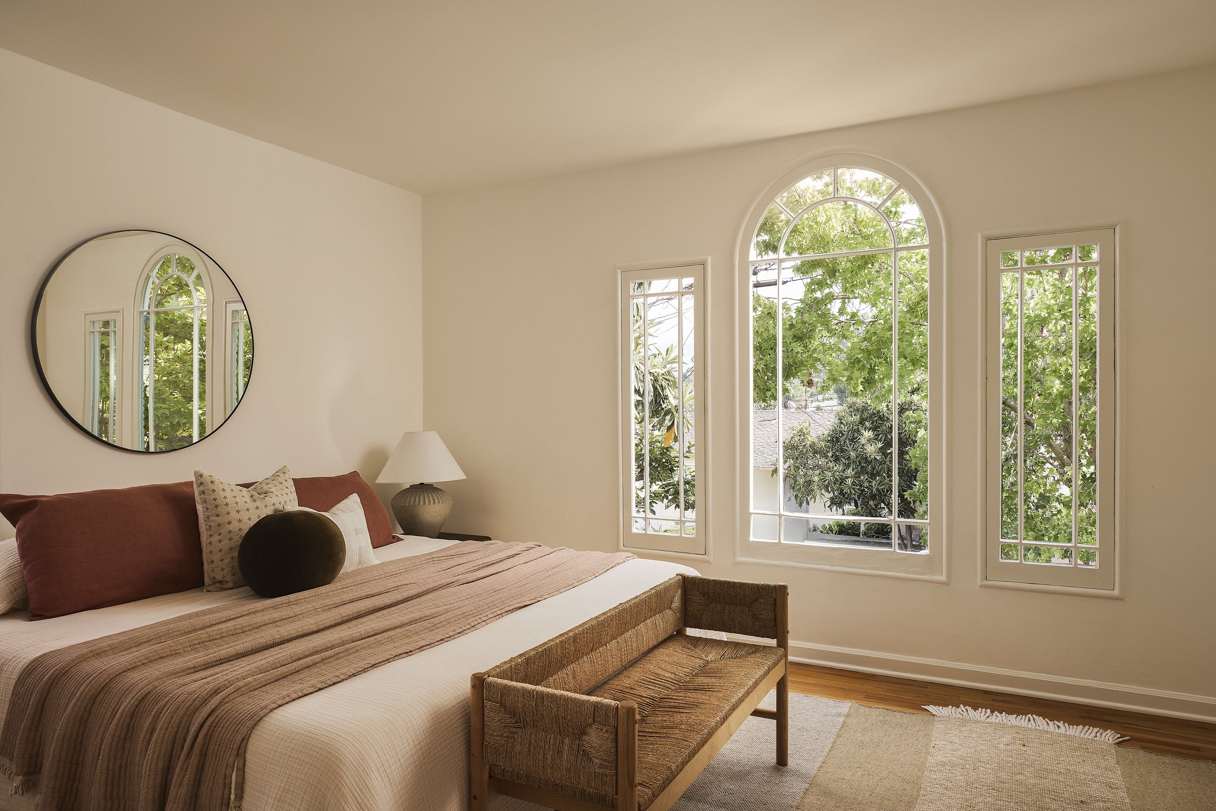 Bedroom with hardwood floors and original windows in a Spanish-style home located in the Adams Hill neighborhood of Glendale