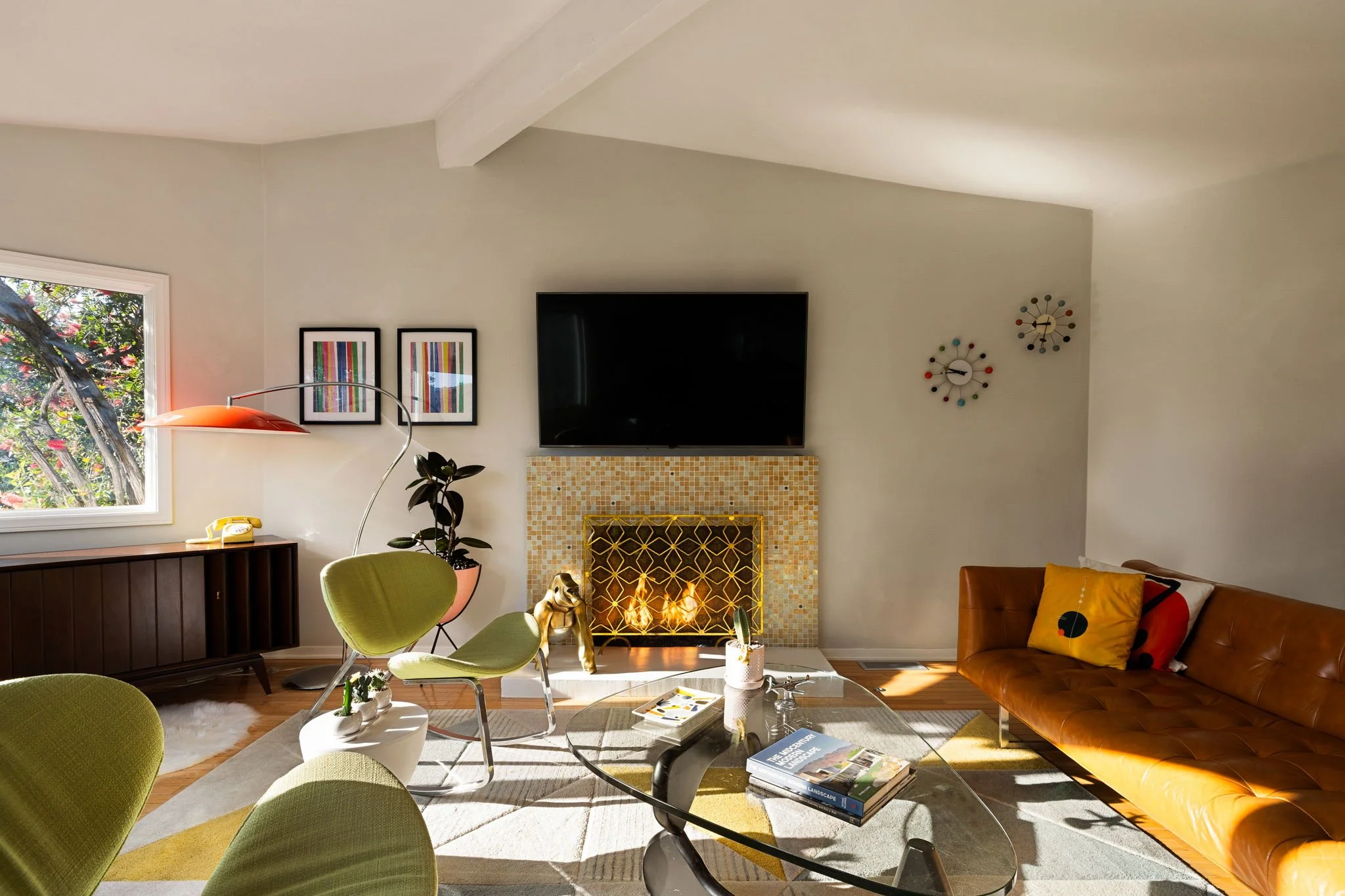 Living room with vaulted ceiling, fireplace, and large windows at 941 Cavanagh Rd Glendale mid-century home