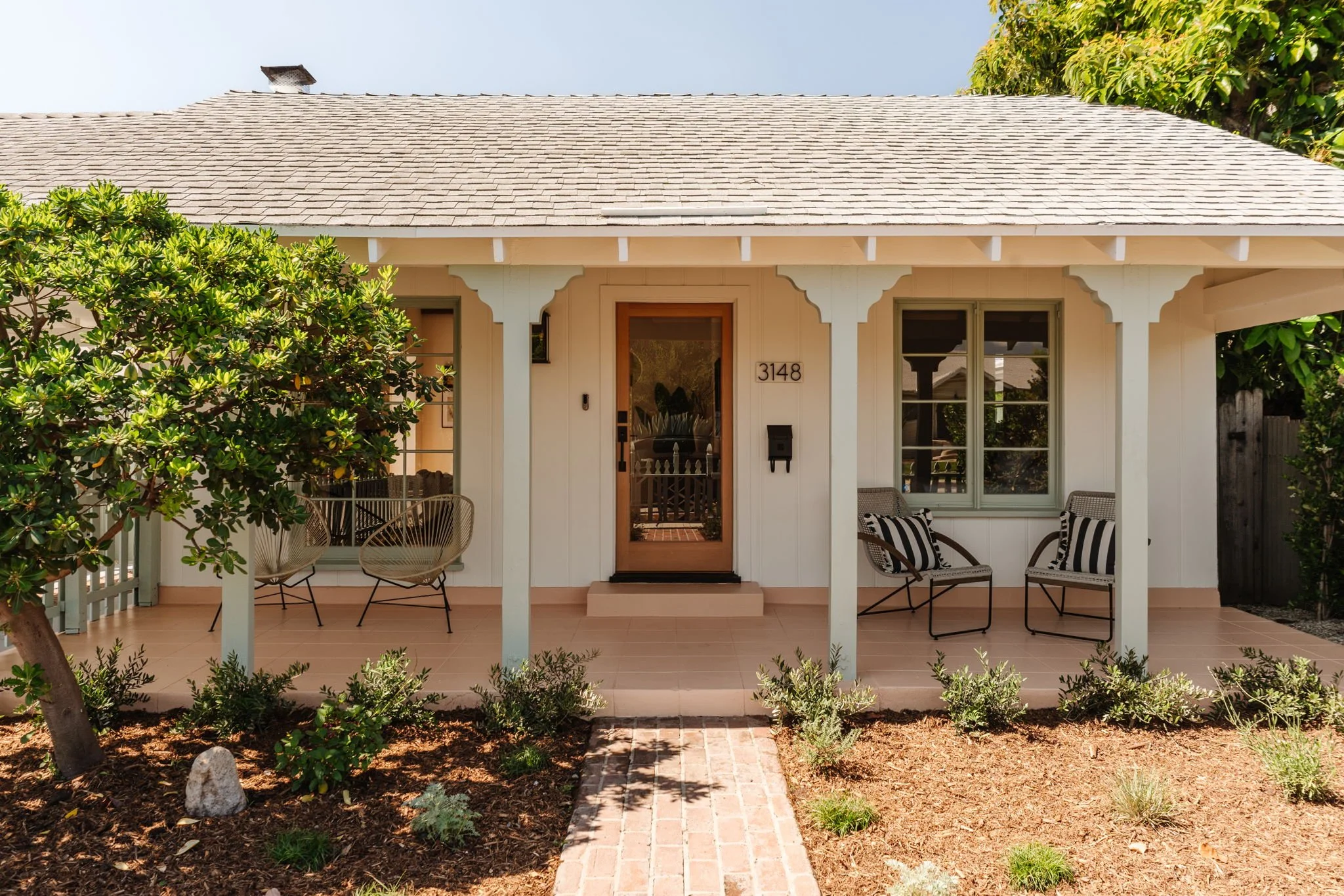 Front porch of a 1936 Craftsman bungalow in Atwater Village Los Angeles with classic wood detailing and landscaped entry