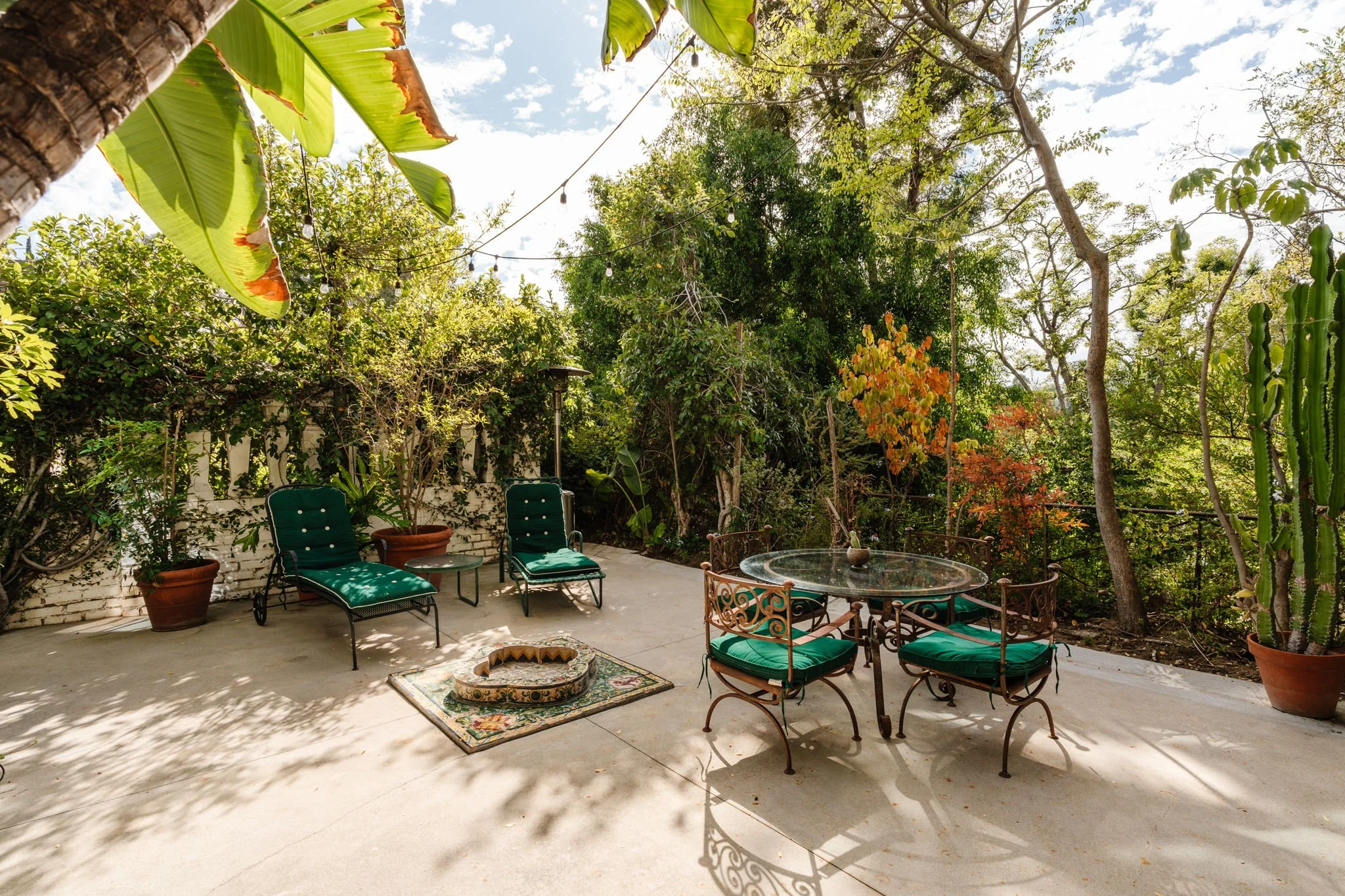 Outdoor entertaining terrace surrounded by mature greenery at 6740 Milner Rd in Whitley Heights