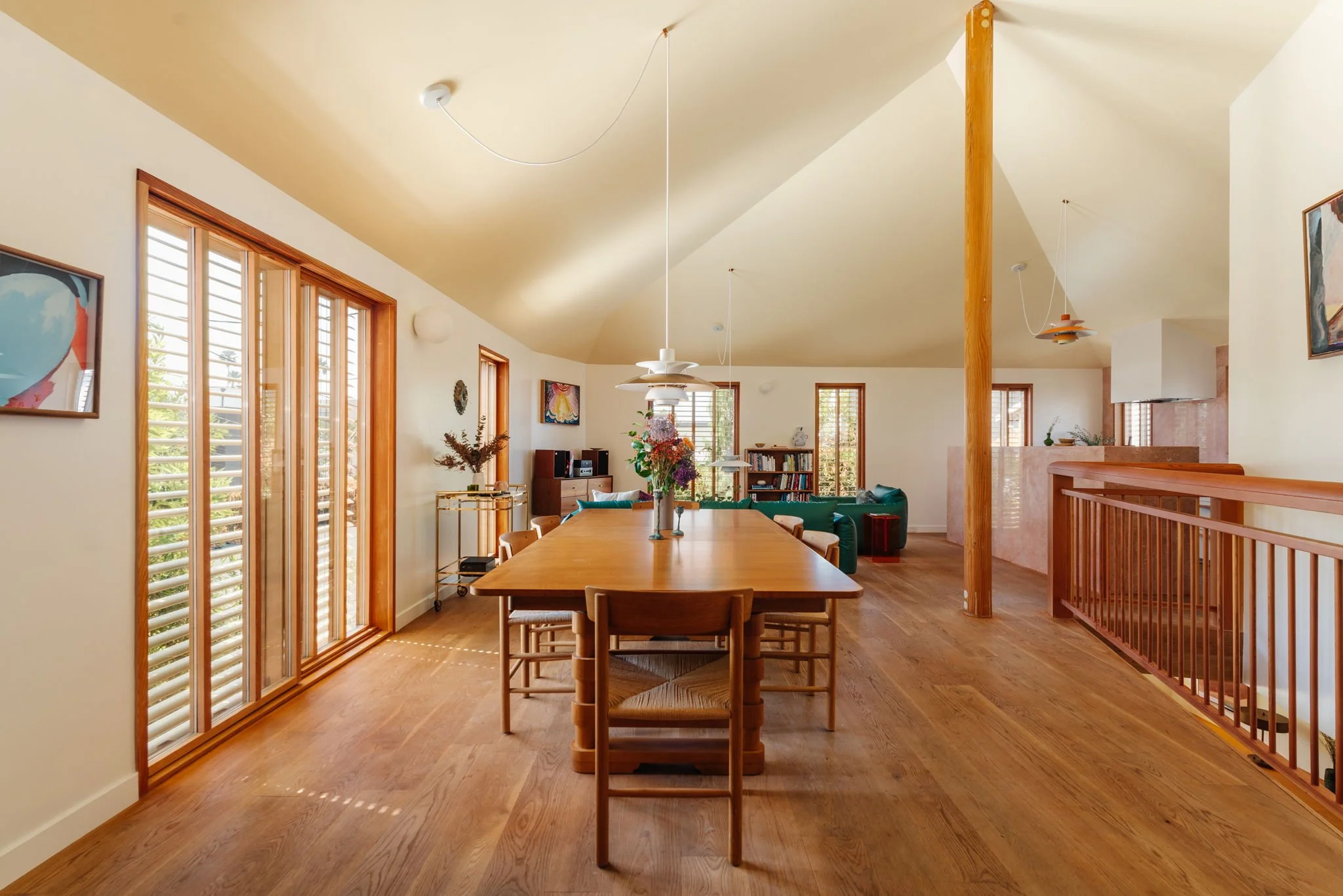 Open living and dining space with vaulted ceilings, white oak floors, and natural light in Silver Lake architectural home