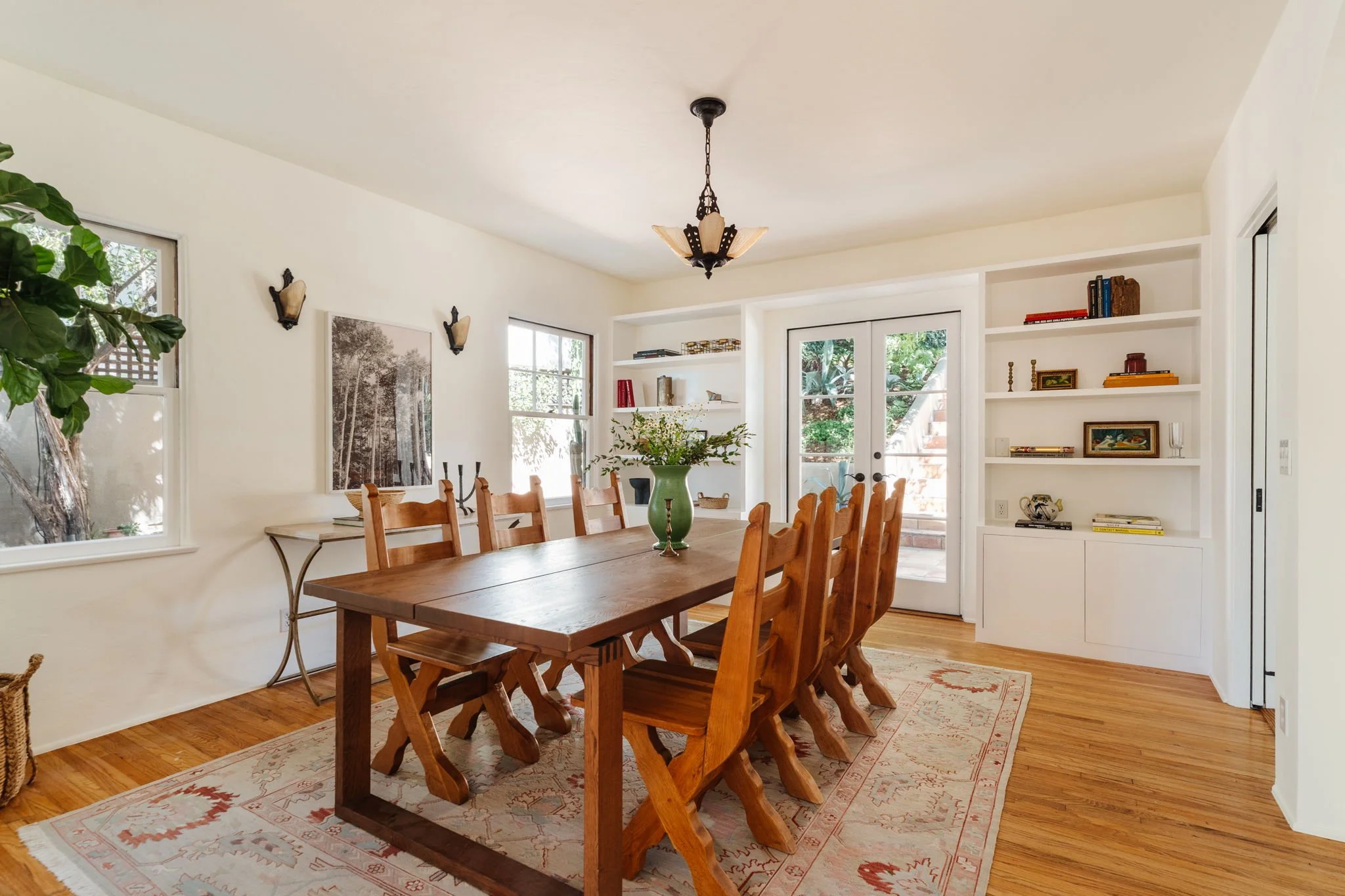 Spanish home dining room with hardwood floors and built-in shelving in Silver Lake