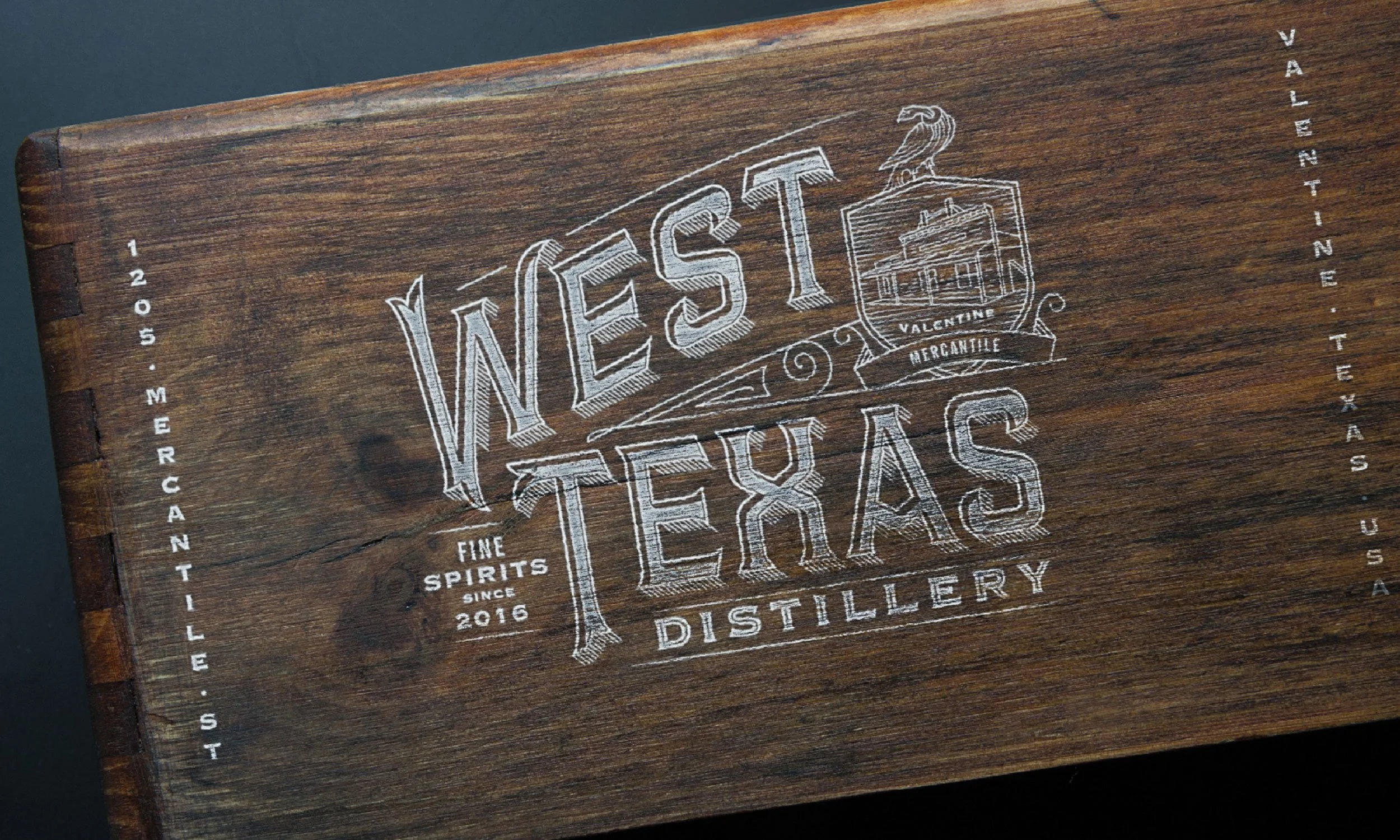 Wooden box with "West Texas Distillery" branding and address.