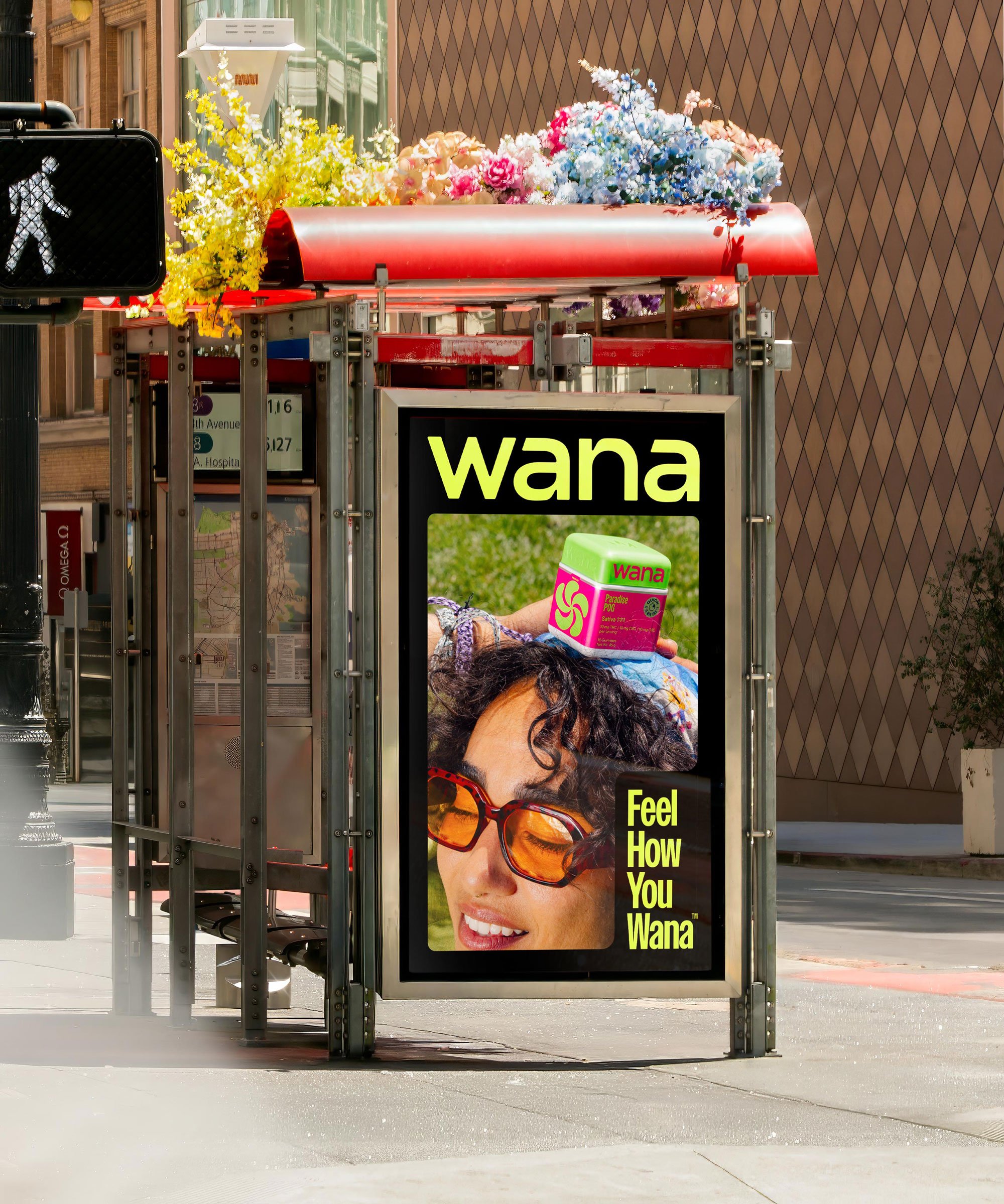 A bus stop illuminated sign displaying a woman with sunglasses, a box of Wana CBD gummies, and the text "Feel How You Wana".