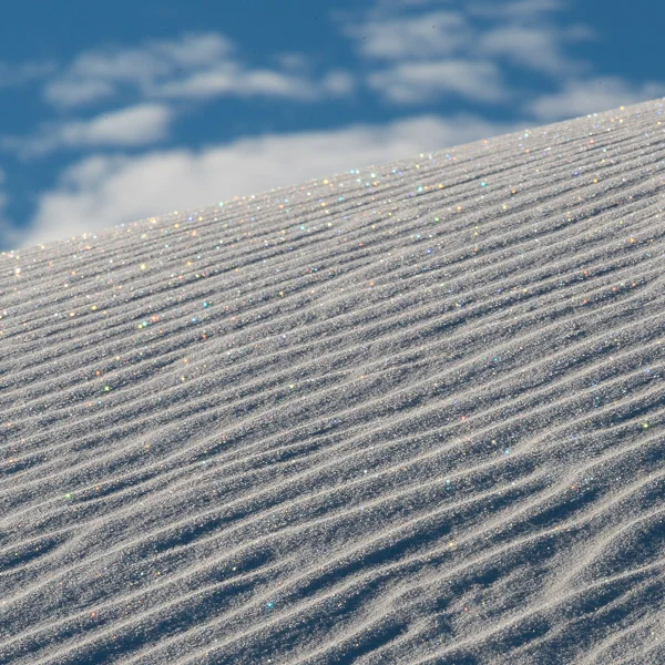 White Sands National Monument. I'm not sure if this photograph is a keeper, but the many-colored reflections from the sand (mica) there if you got just at the right angle made one of my favorite sights I've ever seen. 
