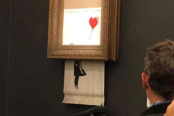 Banksy's Girl with a Balloon appeared to shred itself after selling for $1.4 million at Sotheby's on Friday night. Courtesy of Sotheby's.
