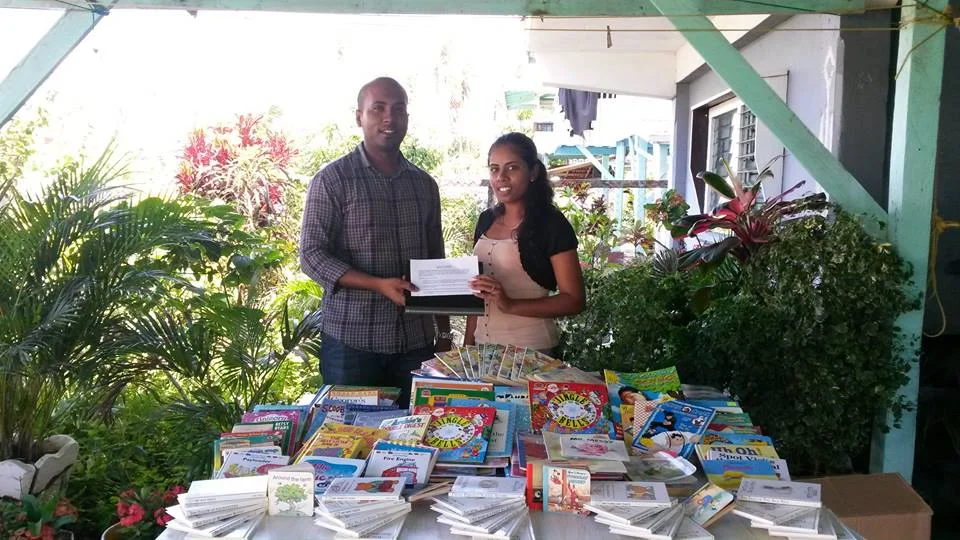 President of Youths in Unison, Rebekah Timram, receiving children's storybooks from GF's Managing Director, Mr. Anthony Autar. 