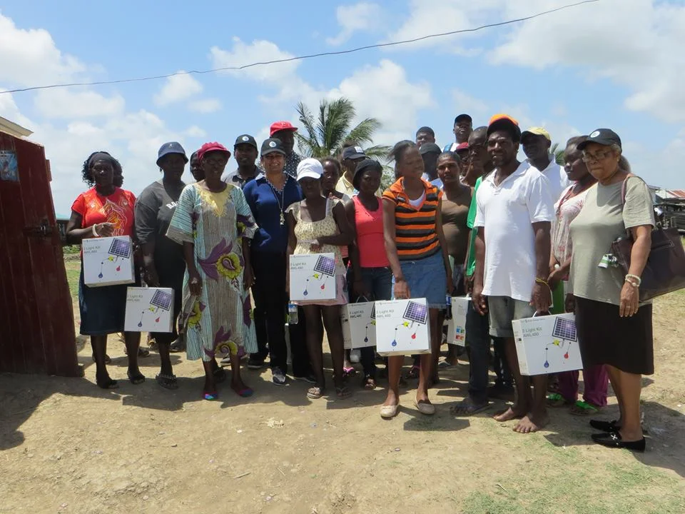Recipients of solar light kits with a team from the Guyana Foundation in Breezy Point.